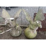 A pair of composition gate finials each moulded as a bird of prey.