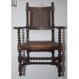 An oak barley twist armchair, early 20th century, with a pierced rattan back and seat, height 114cm,