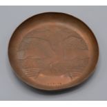 A Newlyn copper circular tray, decorated with a seagull perched on a rock, diameter 13.7cm.
