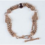 A gold fob-watch chain set with a red stone. Condition report: Weight 17.5g.