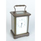 A brass carriage clock, the white enamelled dial with roman numerals, height of case 11cm,