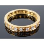An 18ct gold post war half hoop diamond set band with chased flowers and leaves.