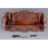 A carved oak pipe rack, early 20th century,
