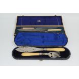 A cased pair of silver plated fish servers, length of box 37.