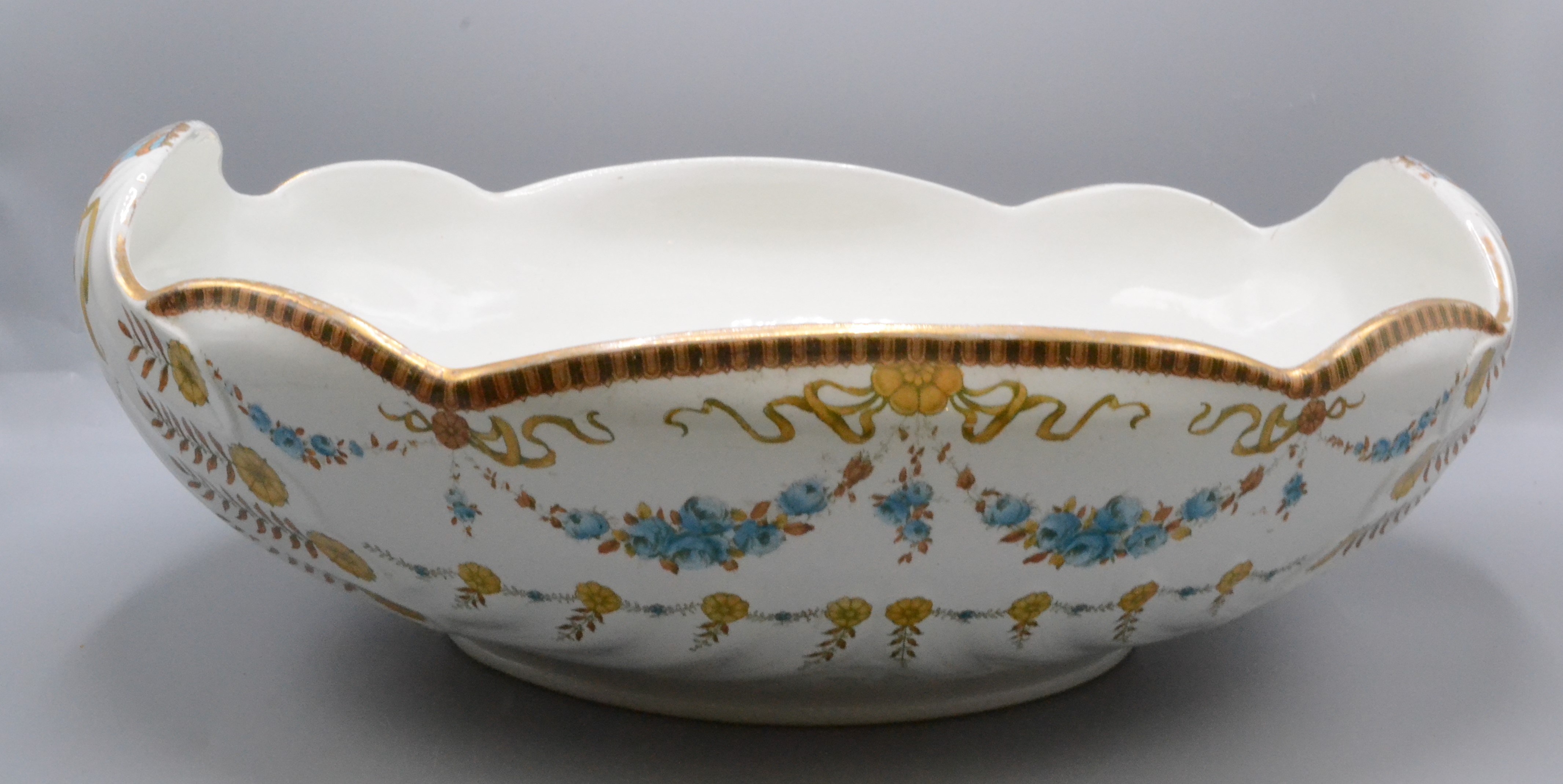 A large The Foley 'Faience' fruit bowl, decorated with floral swags, height 14.