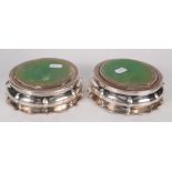 A pair of George IV silver wine coasters each of lobed form with panelled base the central silver