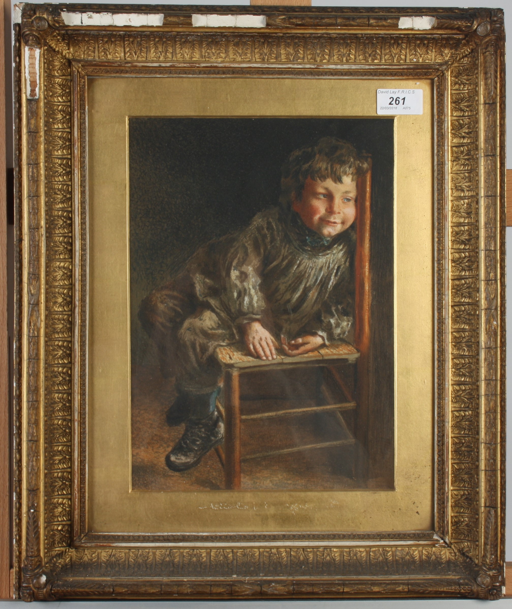 A watercolour of a seated boy, 19th century, in a decorative gilt frame, 50 x 41cm.