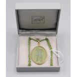 A Lalique green glass Cupid pendant, original box.