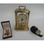A contemporary Sewills New Millennium mantel clock, height 20cm, an alarm clock and a pocket watch.