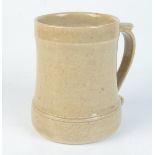 A Leach pottery cream glazed mug, impressed mark to base, height 11.8cm.