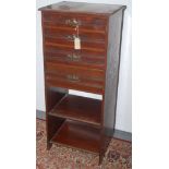An Edwardian mahogany music cabinet, with four graduated drawers above two open shelves,