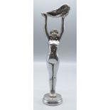 A chrome car mascot of a nude lady holding aloft a feather on a circular plinth, height 24.7cm.