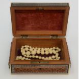 Ivory necklaces in a sadeli box.