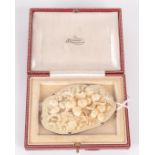 A shaped ivory panel carved with fruiting acorn branches,