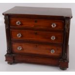 A Victorian mahogany miniature chest of drawers, with three long graduated drawers,
