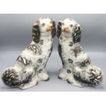 A pair of Staffordshire spaniels, height 32cm, width 29cm and two Royal Doulton character jugs,