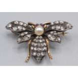 A small gold late Victorian bee brooch pave set with diamonds about a silver pearl thorax and with