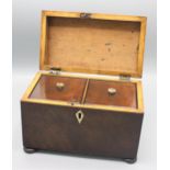 A mahogany tea caddy, early 19th century, the hinged lid opening to reveal twin compartments,