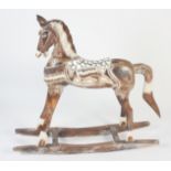 A carved painted rocking horse, height 95cm, length 101cm,width 27cm.