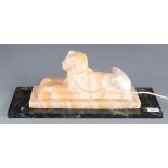 An alabaster lamp in the form of a sphinx, on a marble base, height 21cm, width 51cm, depth 17.7cm.