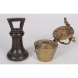 A set of brass stacking cup weights, height 9cm, and a bronze bell weight, height 13.5cm.