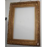 A large gilt composition frame, 19th century, moulded with fruit and leaves, 135 x 97cm,