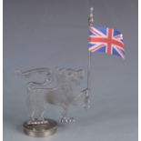 A chrome car mascot of a stylised lion holding a flagpole with Union Jack, height 25cm,