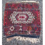 A small Persian kelim rug, with a central polychrome hooked medallion, 81 x 76cm.