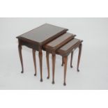 A nest of three walnut tables, 20th century, each with a burr top on cabriole supports on pad feet,