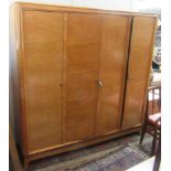 A French burr maple veneered part bedroom suite, comprising a wardrobe, a pair of bedside cabinets,