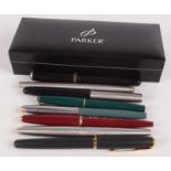 Eight Parker fountain pens.