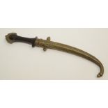 An Islamic dagger, the brass sheath decorated with scrolls and cartouches,