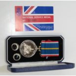 A National Service medal with presentation card no.