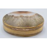A George III oval snuff box the side ribbed gilt metal the lid and base agate.