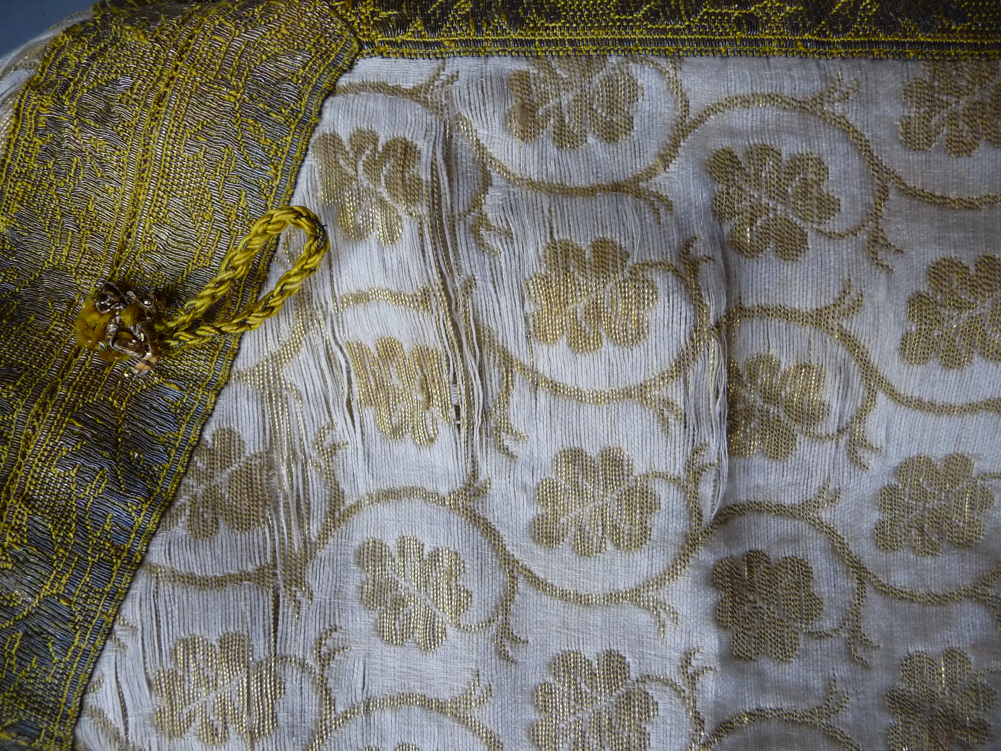 An eastern silk and metal thread over tunic, decorated with floral sprays and leaves, length 101cm. - Image 7 of 8