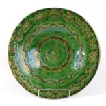 A Spanish green glazed pottery charger,