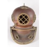 A copper and brass divers helmet, height 45cm, width 44cm.