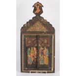 A Persian wall mirror, in a painted wood cabinet with a pair of doors decorated with figures,