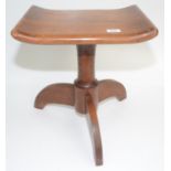 An Arts and Crafts style stool, with a dished seat and downswept supports, height 45cm, width 40.