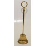 A brass door porter, early 19th century, with a circular handle and lead filled base, height 47cm.