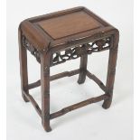 A Chinese hardwood plant stand, late 19th century, the frieze carved with leaves and grapes,