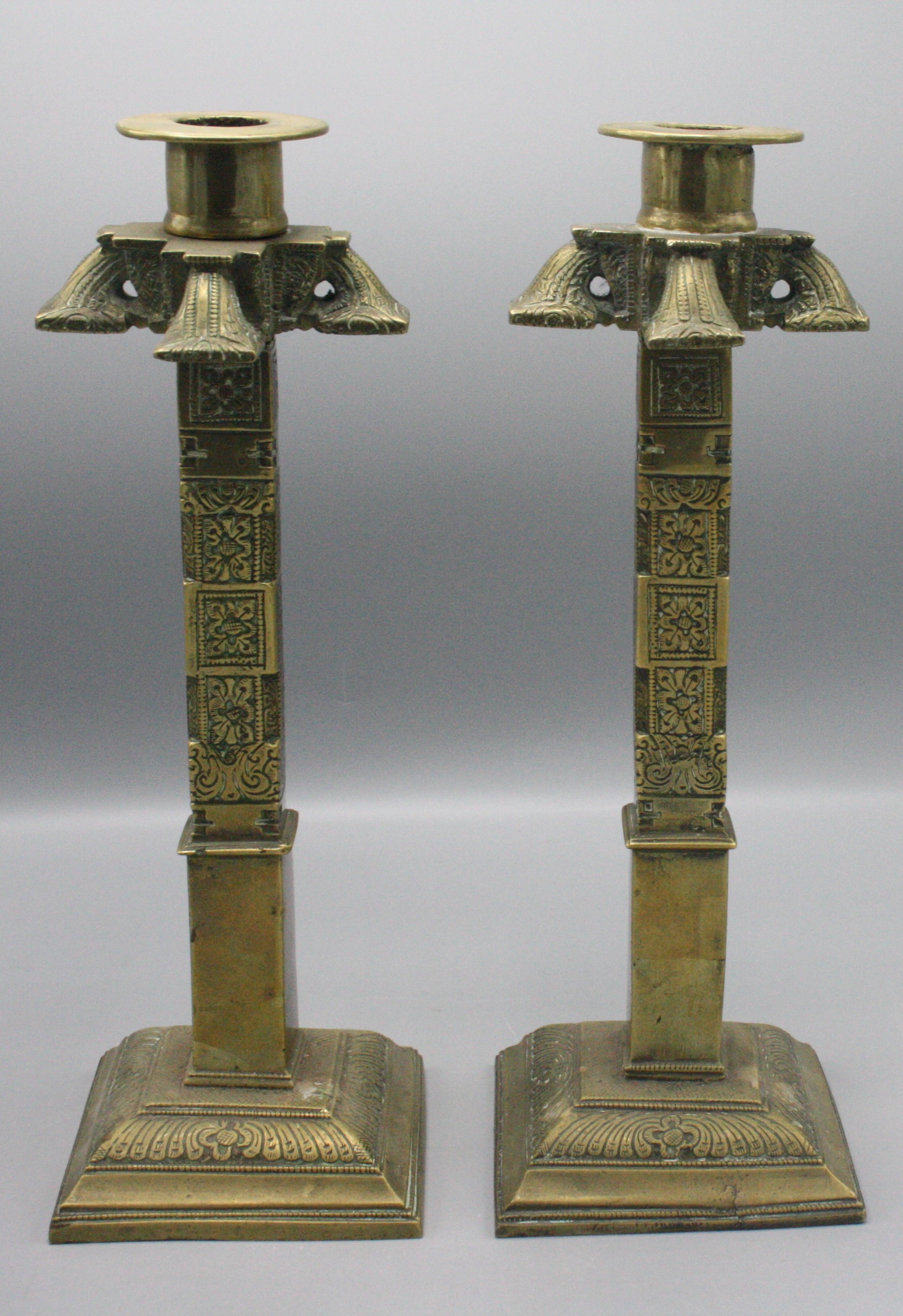 A pair of Indian brass candlesticks, 19th century,