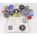 Eighteen miscellaneous glass paperweights and a book entitled 'Paperweights' by John Bedford'.