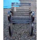 A black painted child's wrought iron garden seat, height 45cm, depth 35cm, width 45cm.