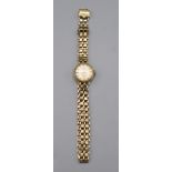 A ladies Rotary gold cased wristwatch on 9ct gold bracelet.