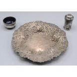 A late Victorian shallow silver bowl repousse decorated in the Carolean style by C S Harris London