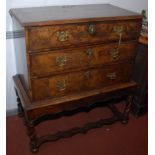 A walnut chest on stand, early 18th century, the rectangular crossbanded moulded top,