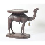 An Anglo-Indian carved hardwood occasional table in the form of a camel,