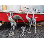 A metal garden figure of a crane, height 59cm, width 57cm and four other models of cranes.