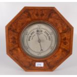 An octagonal figured walnut wall barometer, the 15cm circular silvered dial signed Sewill,